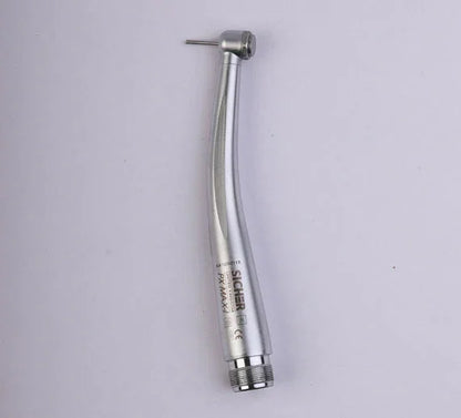 Silver high speed dental airotor handpiece with bur on a plain background