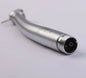 Close-up of a silver dental airotor handpiece on a light background