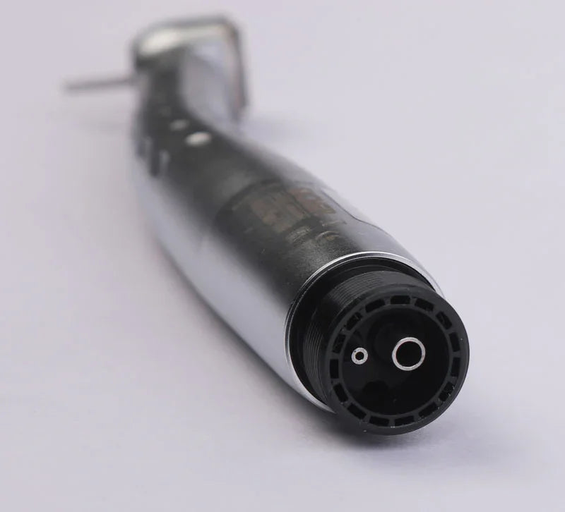 Closeup of a metallic dental handpiece airotor with fiber optic LED on white background