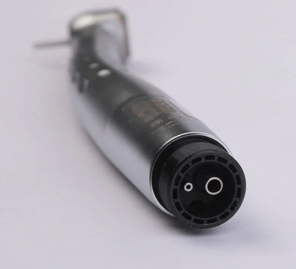Closeup of a metallic dental handpiece airotor with fiber optic LED on white background